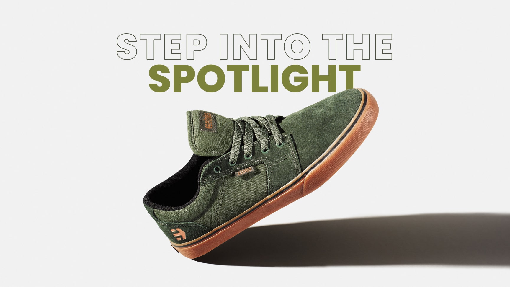 Banner combining design and photography, with the message "Step into the spotlight" and a creative product photography of a green Etnies sneakers shoe, in a step-like position and a long shadow under it.