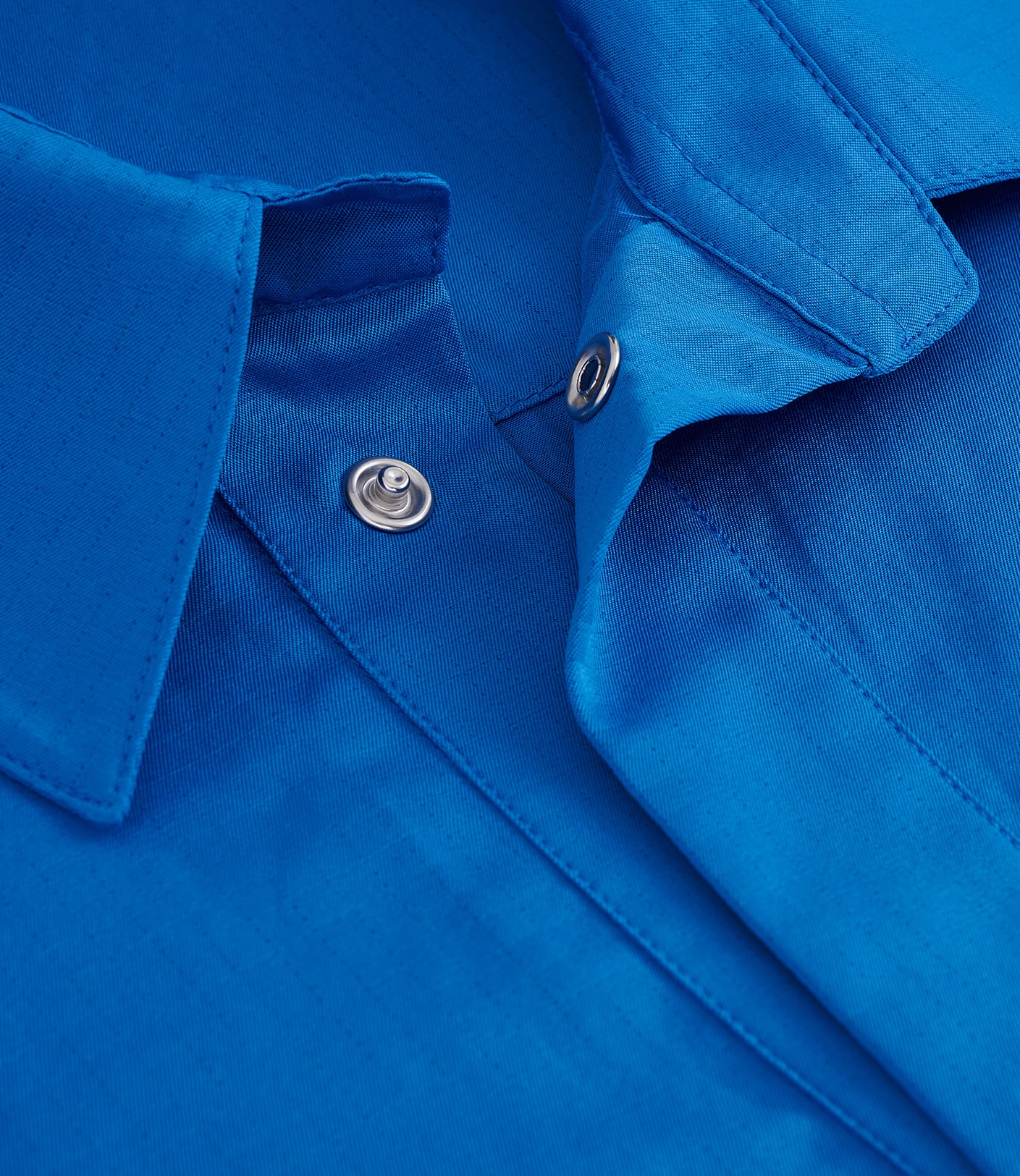 Detail photo of a royal blue lab coat, a close-up product photography for online store